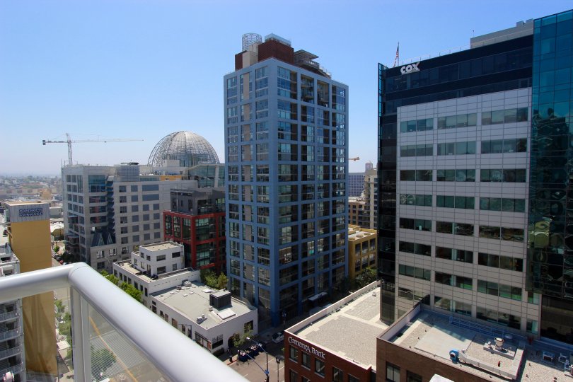 On a balcony in Diamond Terrace overlooking many buildings on a sunny day.