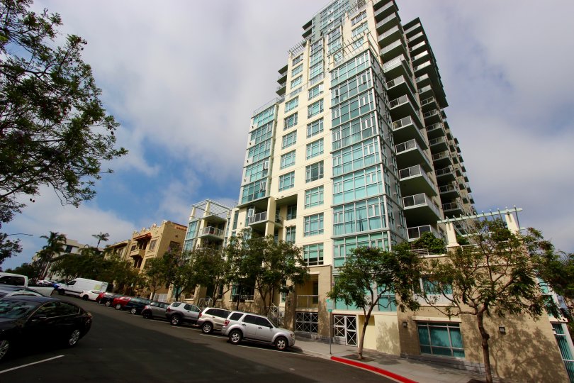 Street view of Apartment building, angled upward picture, trees lining the street