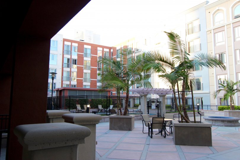 This hotel looks beautiful nearly lot of apartments are there and chairs are there and the coconut trees also there in Gaslamp City Square