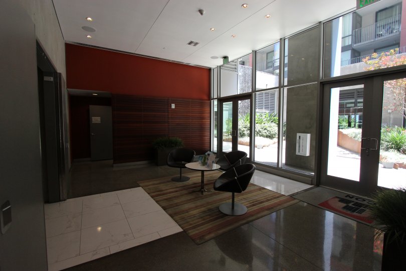 This the lobby of the hotel which has the beautiful glass doors and chairs and also the plants in Icon neighborhood of Downtown San Diego