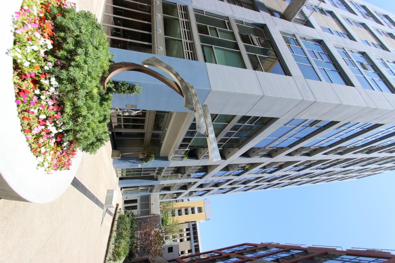 in the suny day there is a building and flowers ! beautifull day