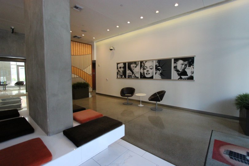 A luxurious well-lit apartment complete with stone floors, modern decor, and black-and-white vintage photos.