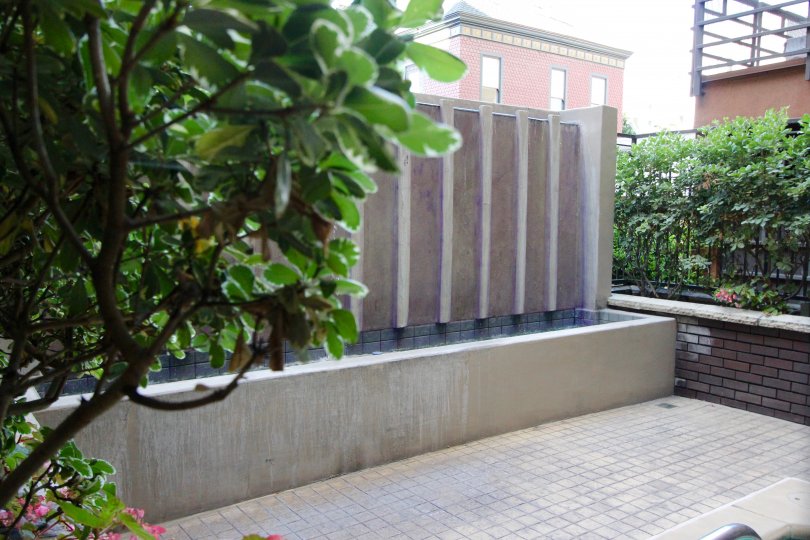 A view of the water feature on a terrace with a brick wall at Park Blvd East.