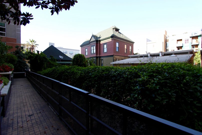 A black fence sits next to a courtyard at Park Blvd East