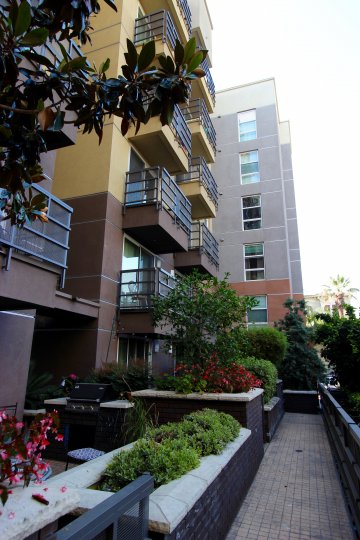 A porch with flower beds and a grill at Park Blvd East in downtown San Diego, CA