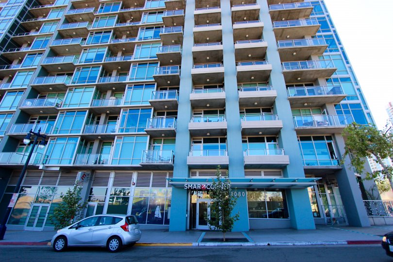 Front entrance of Smart Corner high rise apartments on a sunny day.