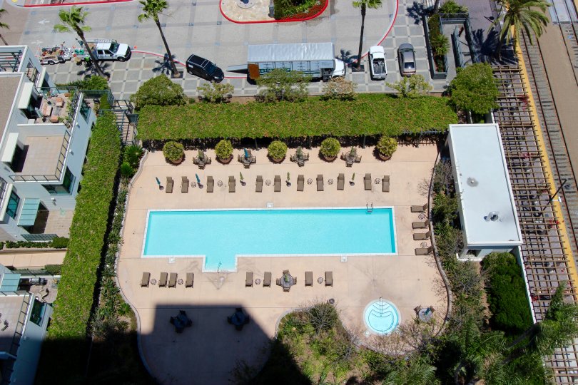 Beautiful sunny view overlooking the pool with patio tables at The Grande.