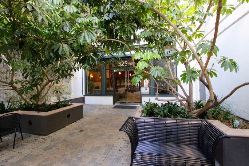 A courtyard with chairs and ornamental plants at The Legend downtown San Diego CA