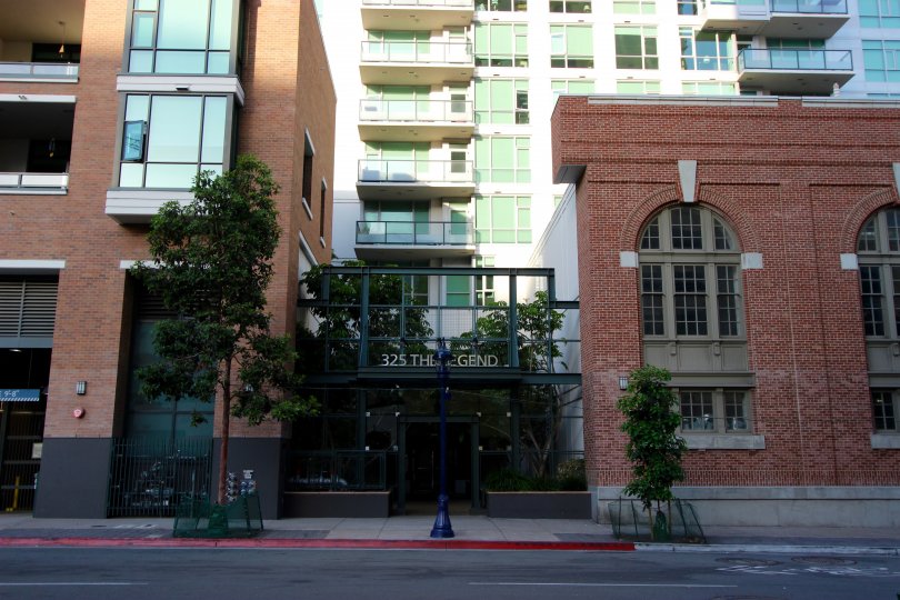 Tall red brick buildings outside of The Legend in Downtown SD CA.