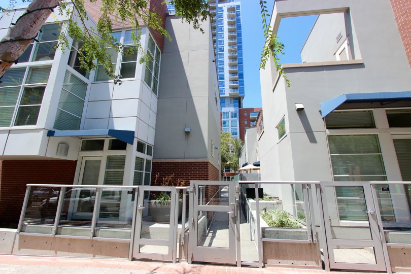 Glass panels in a silver frame half wall sits at the entrance to The Mark condos