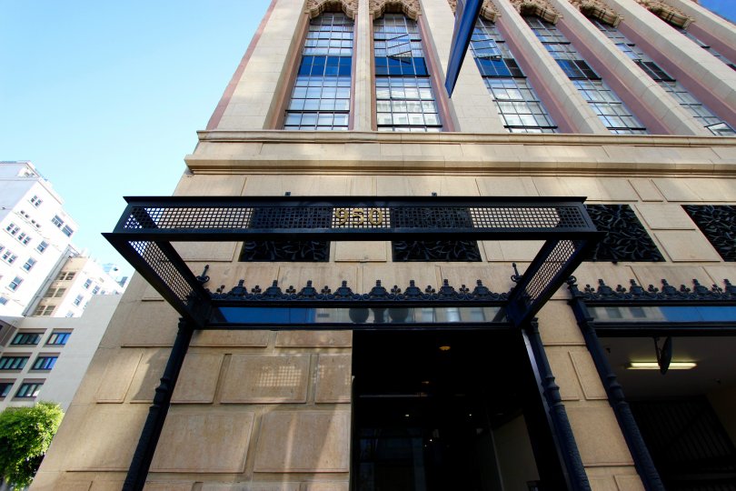 An exterior view of the Union Square building from the street showing black wrought ironwork and multi-story windows on a clear day.