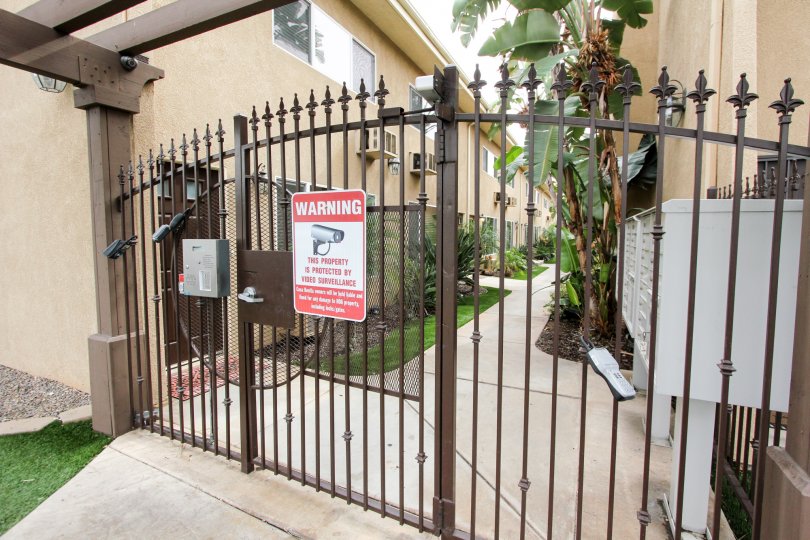 A photograph of a warning sign on a security gate in El Cajon California