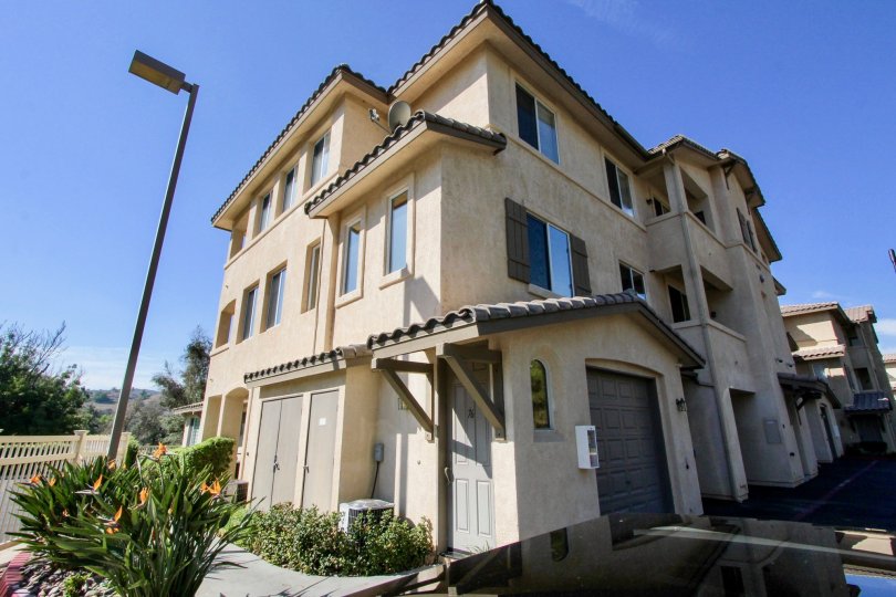 A three-story home with beautiful flower garden in the Fairway Villas community of El Cajon, California