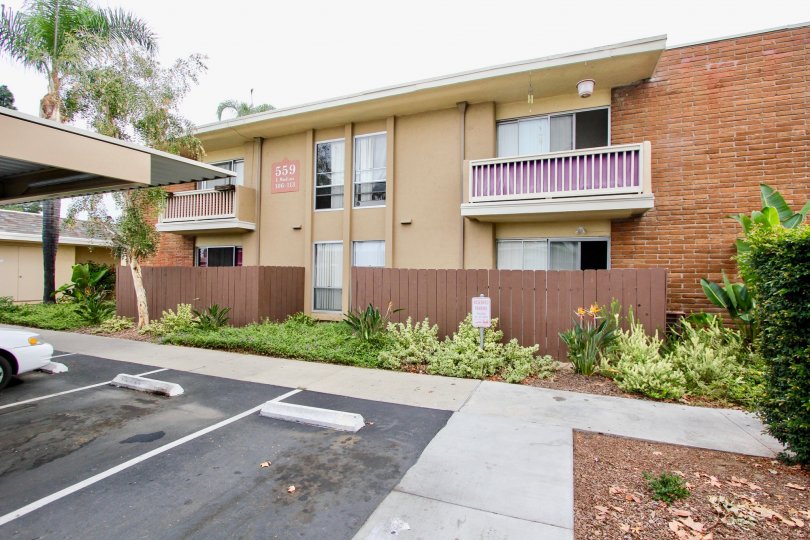 Madison Ave Condos - A residential community located in El Cajon, CA. Pictured here are some units and the parking lot.