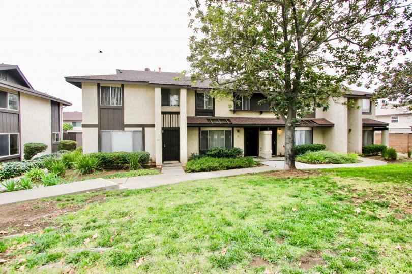 Two story housing with yard and trees at Mollison Villas in El Cajon California