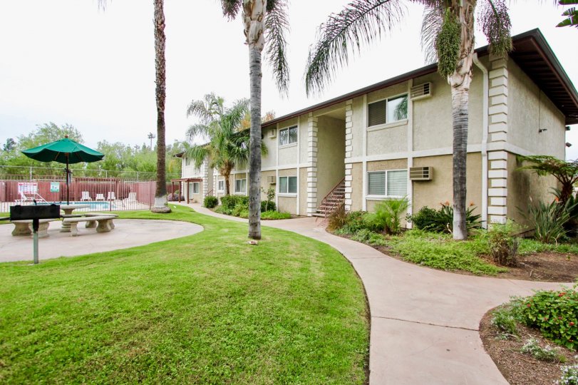 Common area including pool, BBQ, and eating area at Orlando Manor community in El Cajon, California