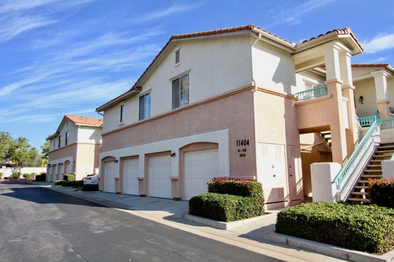 VERY BEAUTIFUL HOUSE. IN FRONT OF IT THERE ARE FOUR SMALL TREES. AND THERE IS A ROAD, VERY CLEAN. AND THERE IS A POOL.