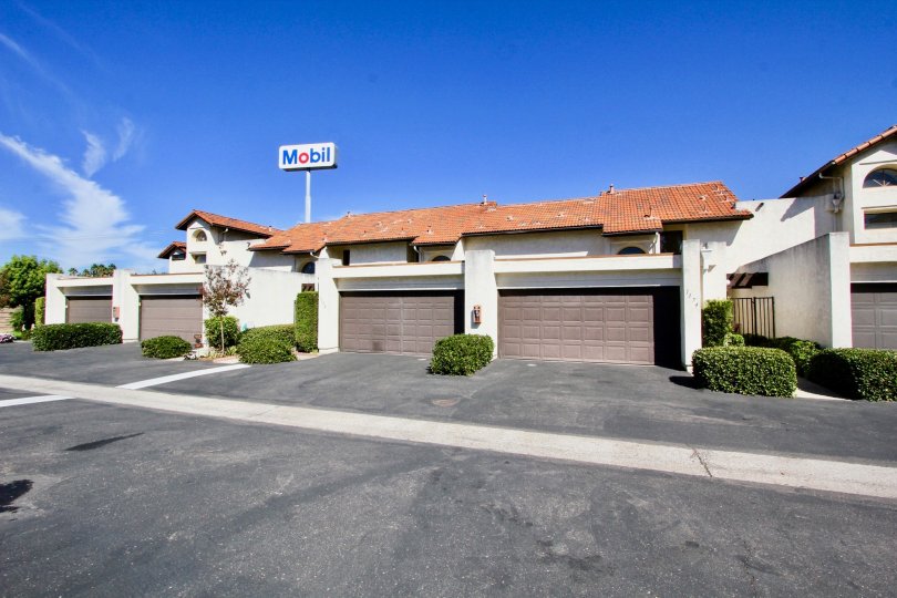 A mobil sign in the distance with four garages in the Sunet Hills Terrace area.