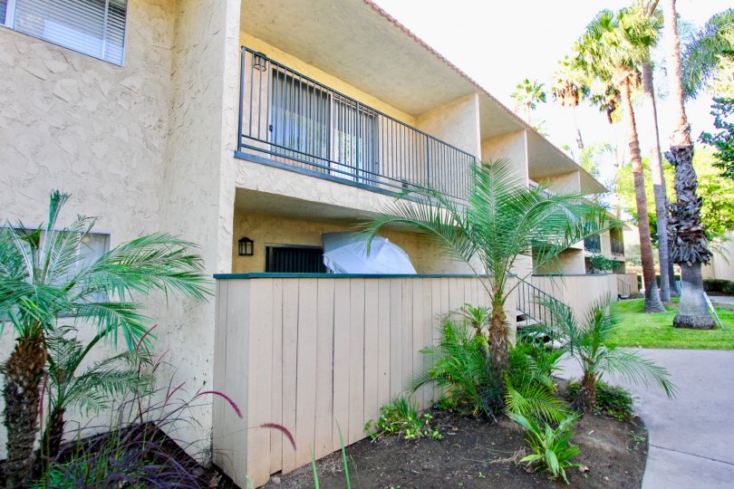 apartment building in Sunterra showing balcony, gardens and trees