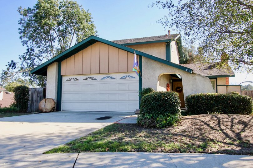 View of 2 car garage of single unit with bushes in Escondido Hills of Escondido California