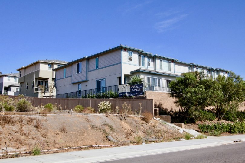 Two story residential buildings with security fence at Level Fifteen in Escondido California