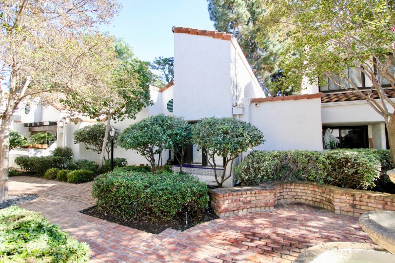 Beautiful brick paved walkways and retaining walls with ample plants and trees at Sunset Woods