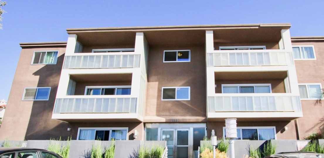 The Apartment with number 3815 On Third has bushes and car is parking