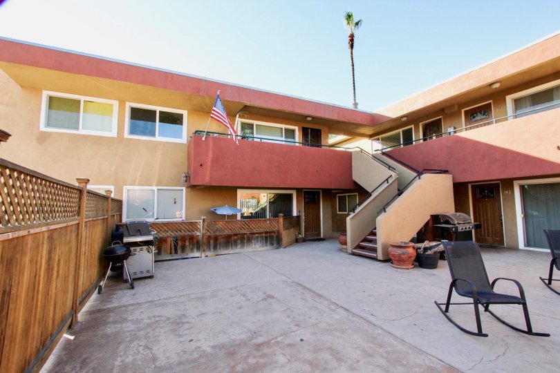 Patio near residential units & flag at Willow Bay in Imperial Beach CA