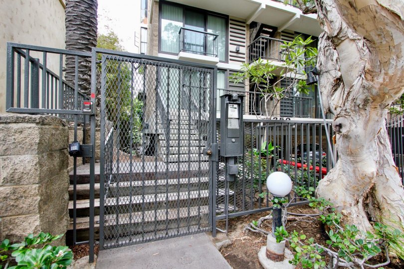 The door side of the villa in 1250 cave street with postal box and trees