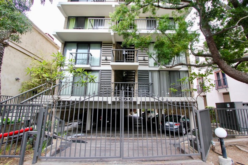 Large black gate in front of a three story home at 1250 Cave Street in La Jolla CA