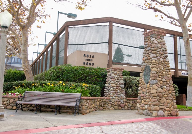 Tall stone pillar with plaque outside the Boardwalk in La Jolla California