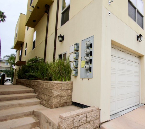 Garage and electrical meters on side of Bonair Street Condos in La Jolla, California.