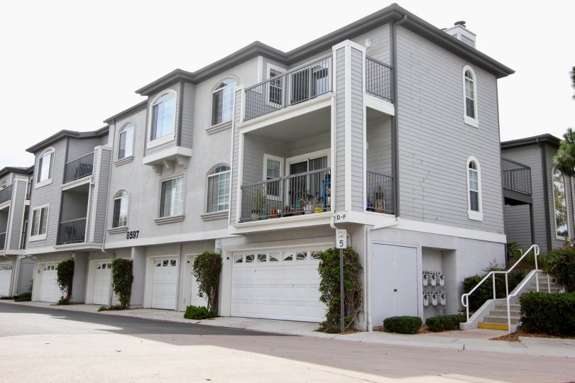 The apartments in Cape le Jolla Gardens has number with 8597 and has street lamp and bushes