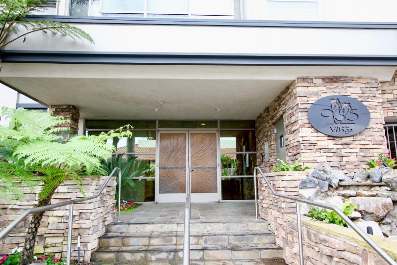 a pleasant day in the chateau girard with a building that has named in black elliptical board and has wide way in.
