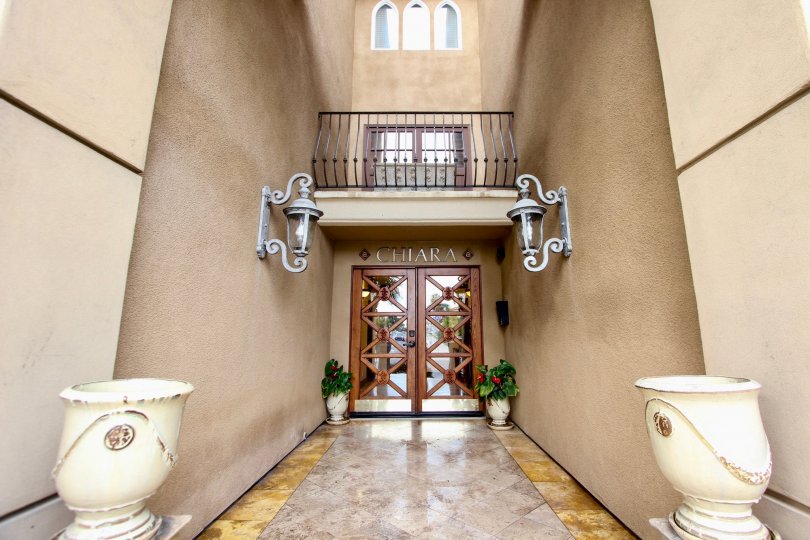 At the entrance of Chiara, Has two flower pots and light lamps attached on the wall on both sides