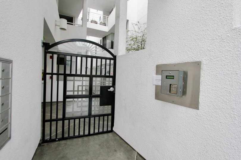 Black iron gate near intercom inside Lighthause in La Jolla California