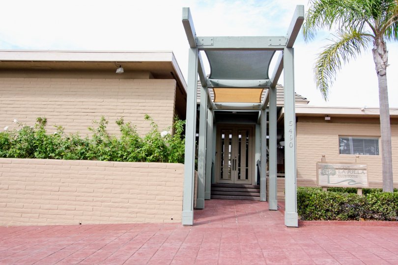 Front view of the Mount La Jolla has the pillars and bushes at both side of the house