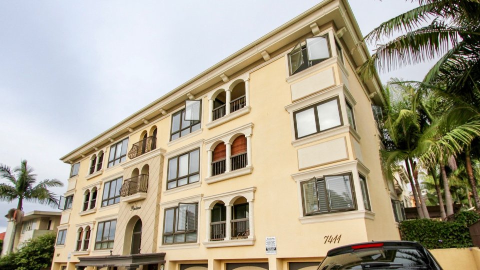 A beautiful multi floor building with palm trees surround in Positano community.