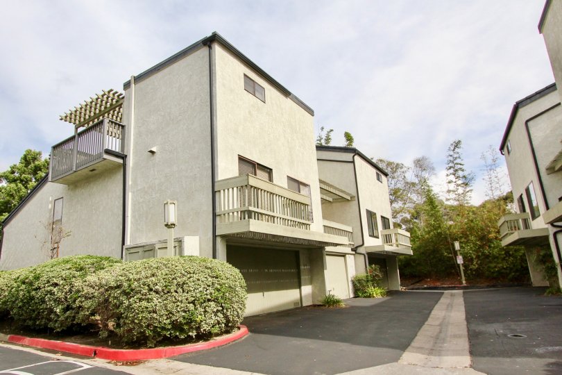 Three story building with large garages inside The Woodlands in La Jolla CA