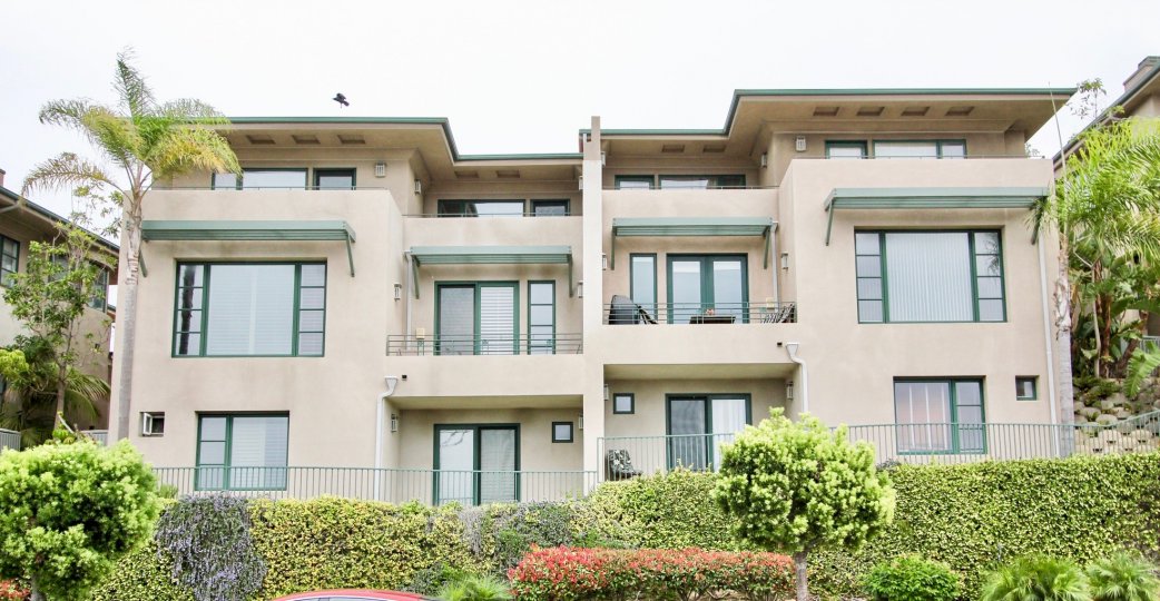 The apartments in the Village point with garden in front the village point has bushes and trees