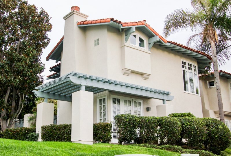 A residential house that has palm tree and various other trees surround in Villas of ivanhoe community.