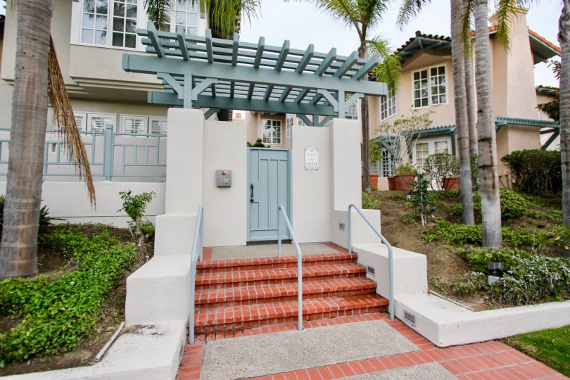 Blue door at the top of red steps inside villas of ivanhoe in la jolla ca