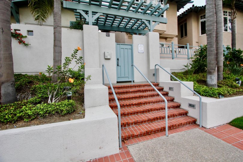 An entrance of a building in the Villas of Ivanhoe with beautiful plants.
