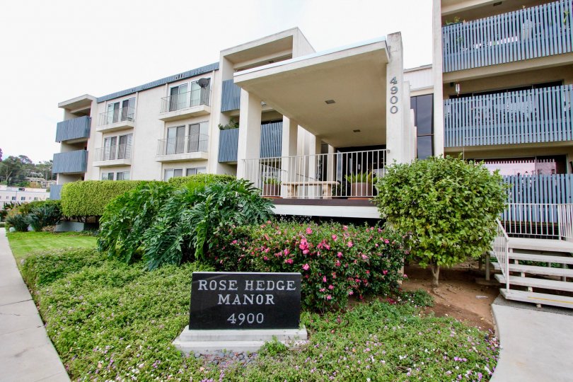 A sunny day in the area of Rosehedge Manor, outside, condos, flowers, bushes, balcony, gate