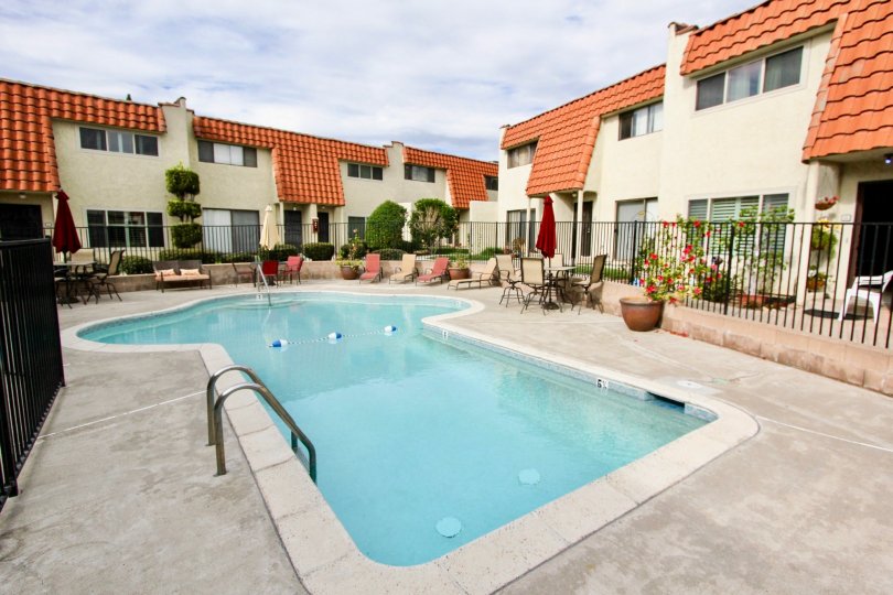 A mushroom shaped pool surrounded by buildings at Tangerine Terrace at La Mesa CA