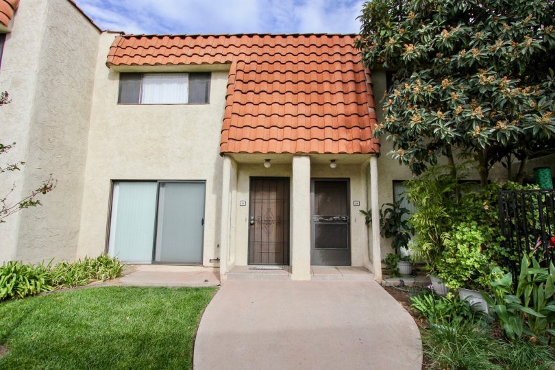 Green trees and lawn in front of a villa in Tangerine Terrace of La Mesa