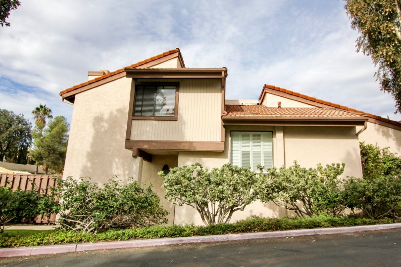 a warm day in the woodlands with a house that has no roof top and also has plant in the sides