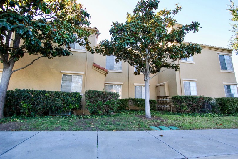 Two story residential building near a sidewalk at Canyon Park Villas in Mira Mesa California