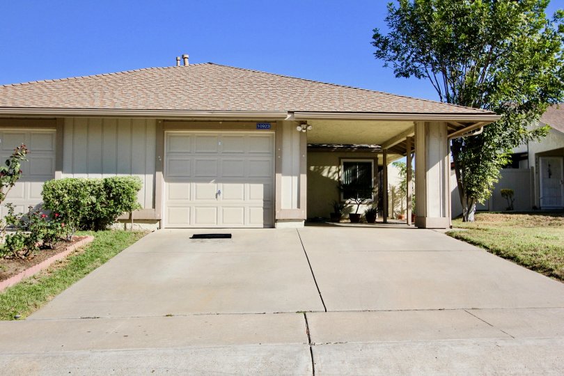 house with a pretty basic design and plenty of space, a garage and plants on each side