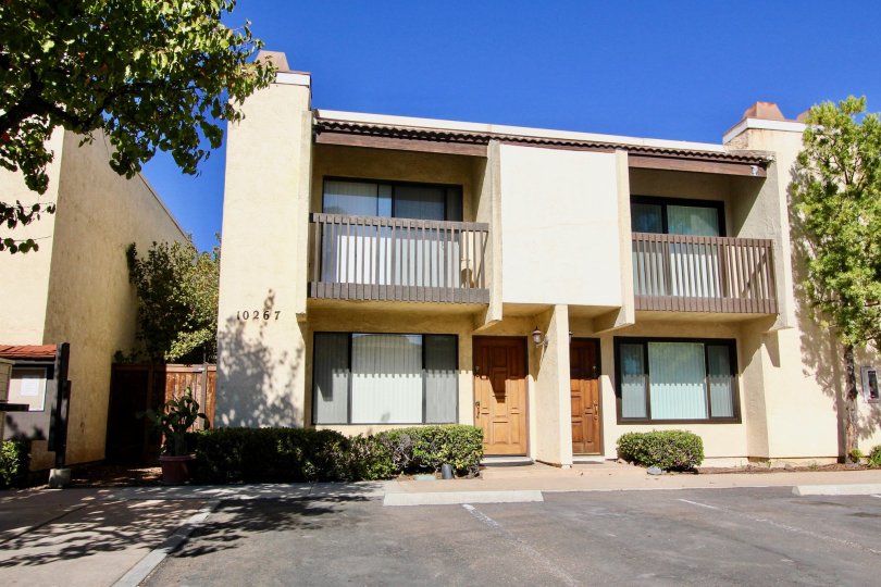 Two apartments and parking spaces, each with their own small balcony.